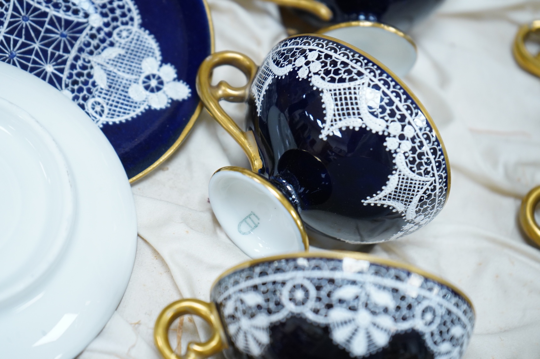 A Vienna-style lace-pattern coffee set, Beehive marks, cased